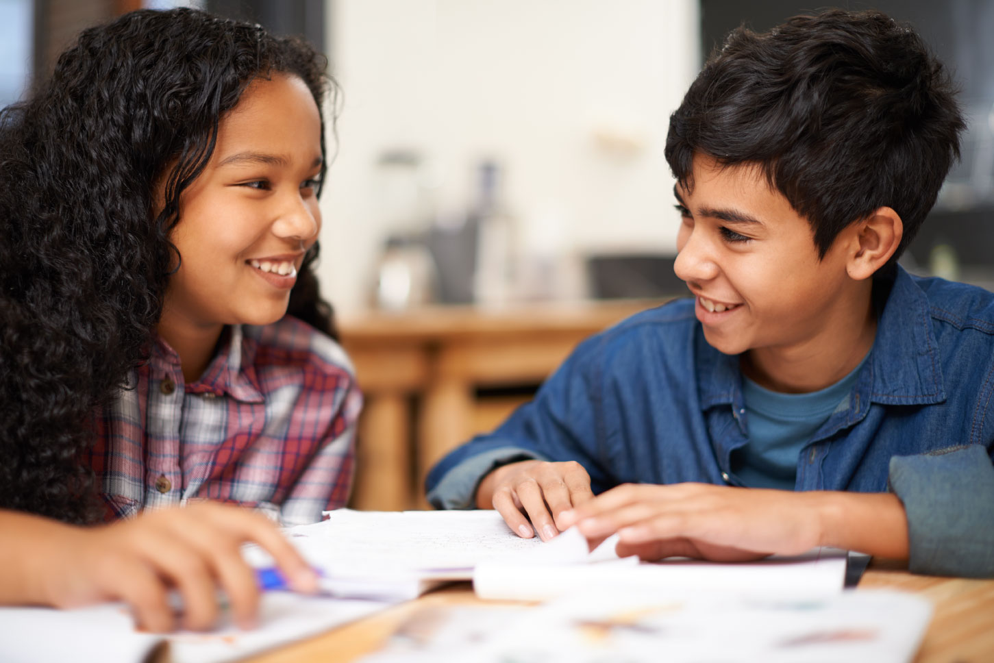 Two students working together with paper