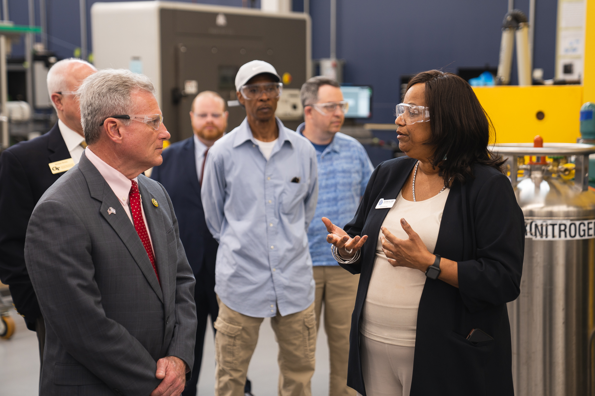 U.S. Rep. Earl "Buddy" Carter, (left) whose Congressional district includes Savannah, listens as  the Enterprise Innovation Institute's Donna Ennis, co-director of Georgia AIM, explains how artificial intelligence is being utilized to drive innovation. (PHOTO: Chris Ruggiero)